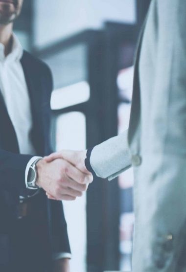 Closeup shot of two businesspeople shaking hands in an office